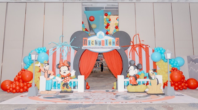 Disneyland themed entrance arch with Mickey characters